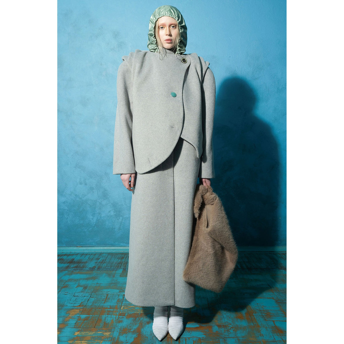 Model wearing grey wavy ruched wool-blend vest with vintage buttons by MASHAT