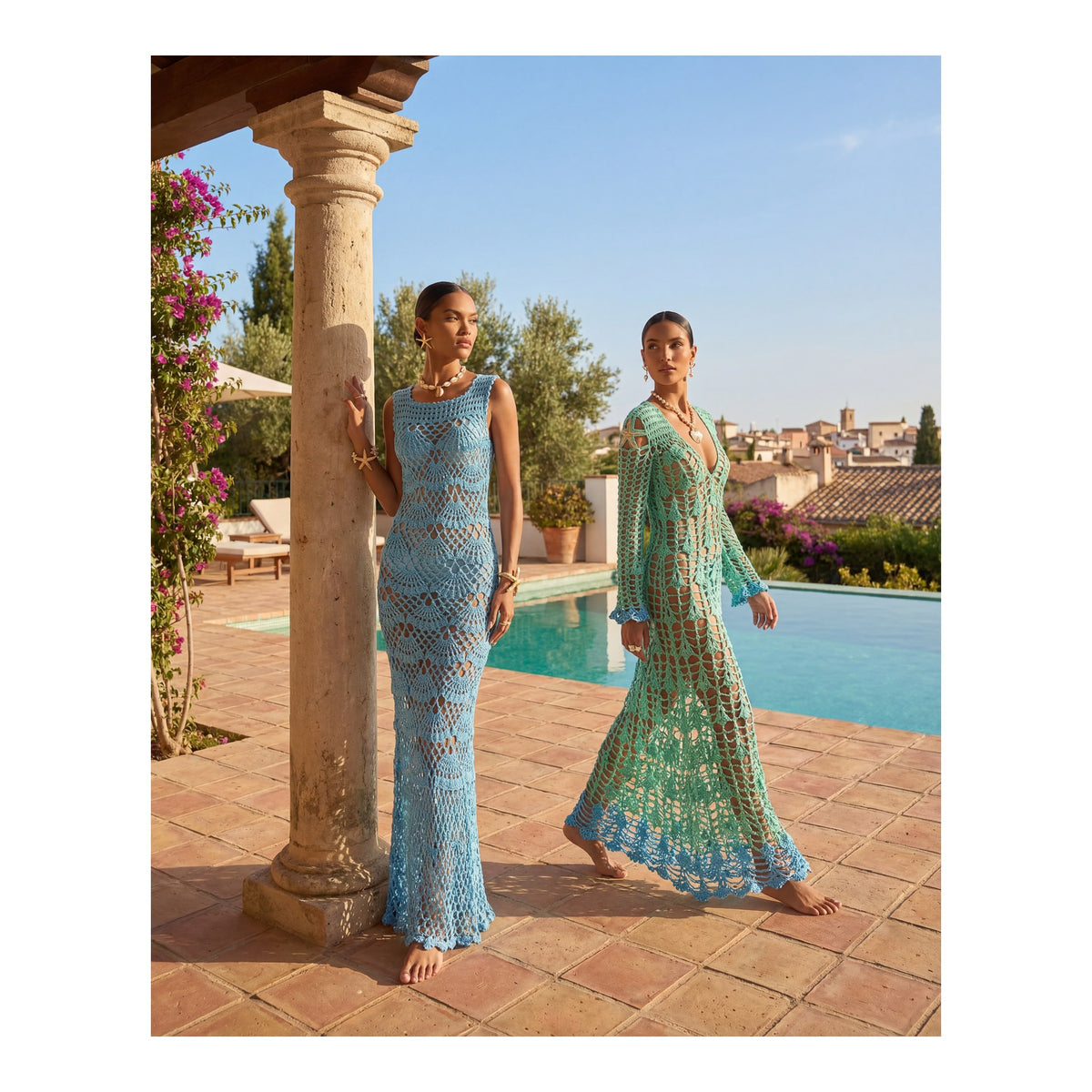 Two women in light blue crochet dresses, including the ANDREEVA Aqua Marine Handmade Maxi Cover-Up Dress, stand by a poolside patio with terracotta tiles and a stone column, surrounded by lush greenery and rooftops in the background.