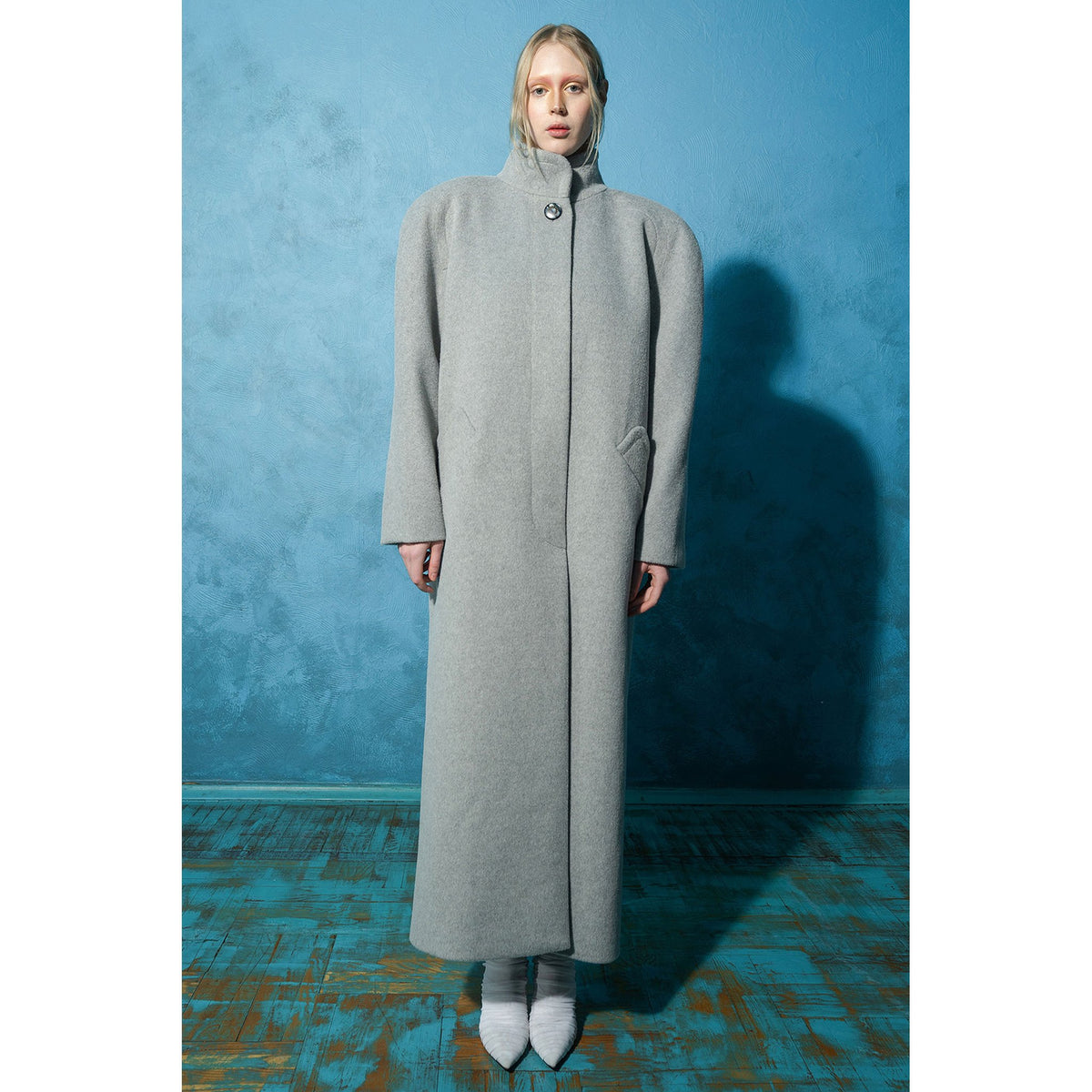 Model wearing grey wool-blend maxi coat with vintage buttons by MASHAT