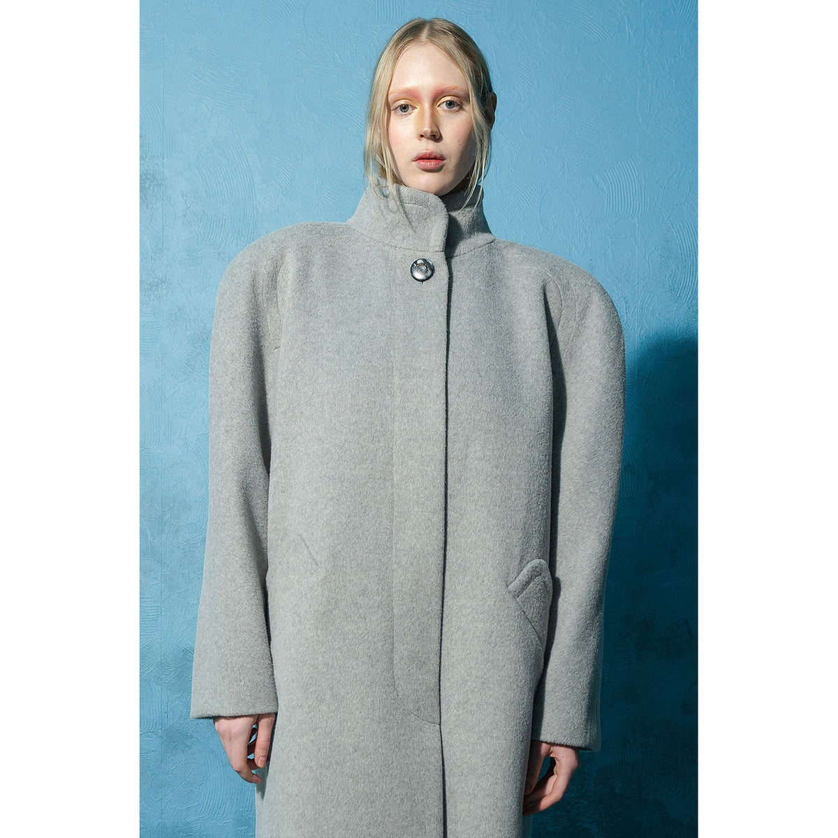 Model wearing grey wool-blend maxi coat with vintage buttons by MASHAT