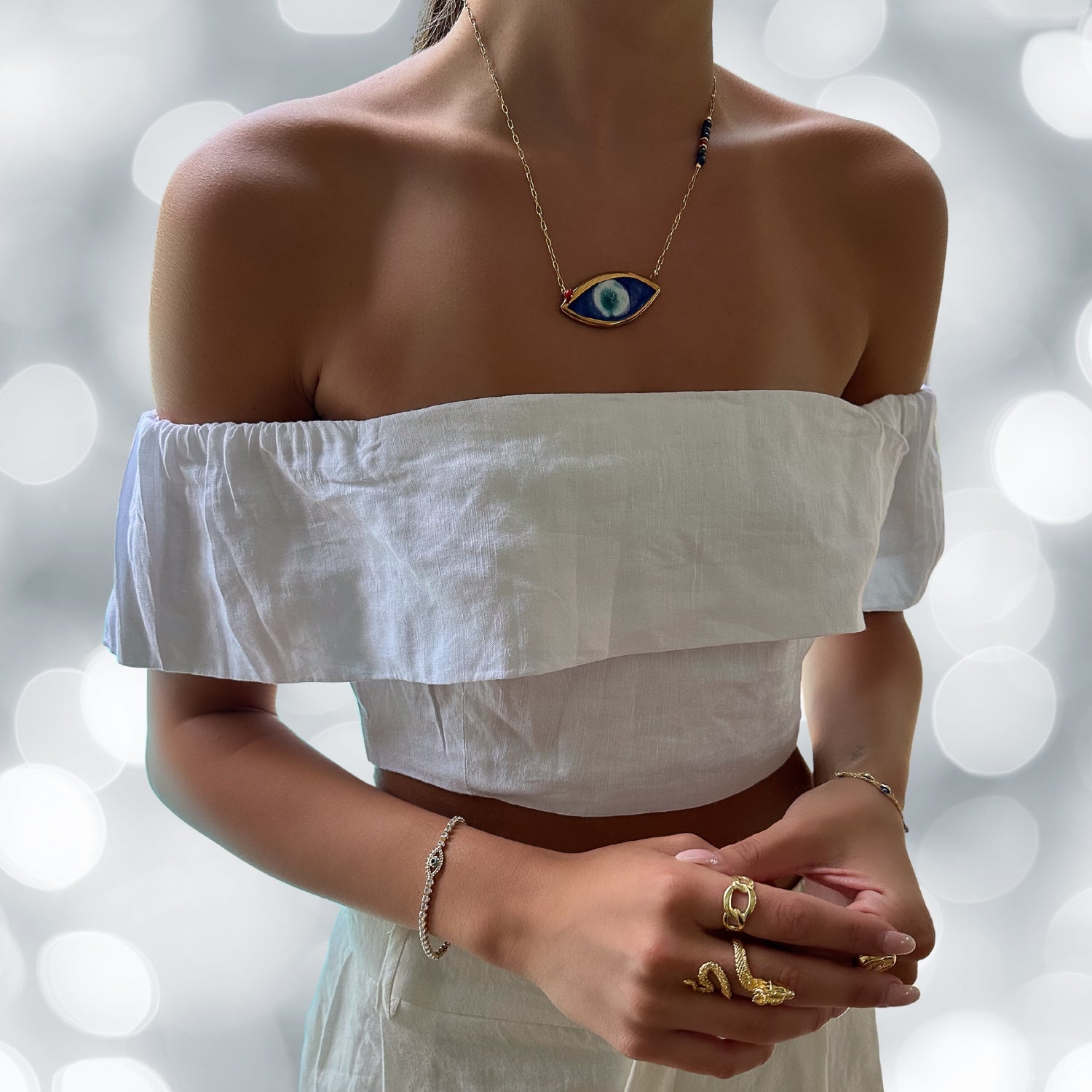 Model Adorns Energy Anchor Evil Eye Pendant Necklace - Elegance and Protection.