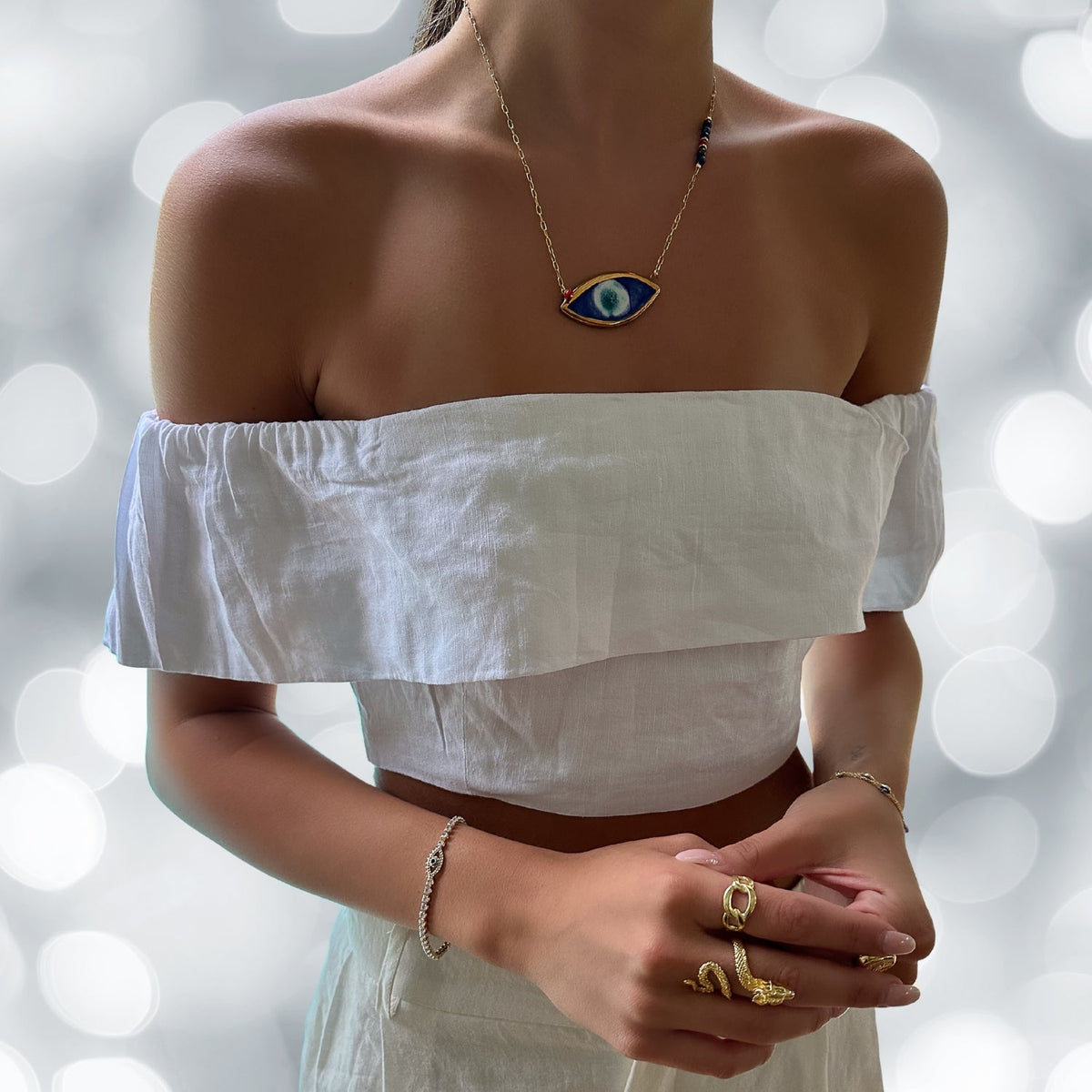 Model Adorns Energy Anchor Evil Eye Pendant Necklace - Elegance and Protection.