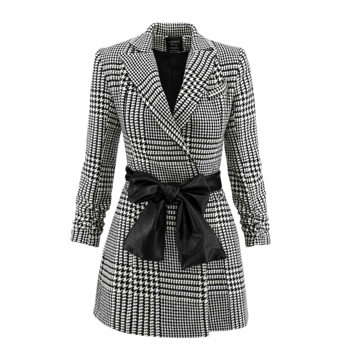 Houndstooth patterned coat with a black belt on a white background