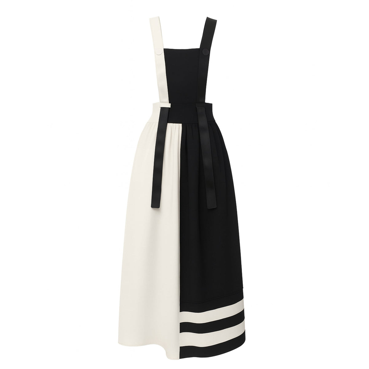 The JULIA ALLERT Midi Apron Dress With Adjustable Straps in Black Ivory features a fitted waist, wide shoulder straps, sash belt, and an ankle-length design with one solid black side (with two white hem stripes) and one solid white side.