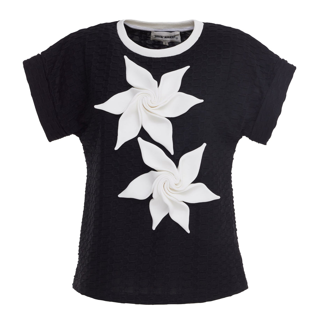 The JULIA ALLERT Black Short Sleeve Top With Floral Detail features structured fabric and two large white 3D pinwheel flowers on the front.