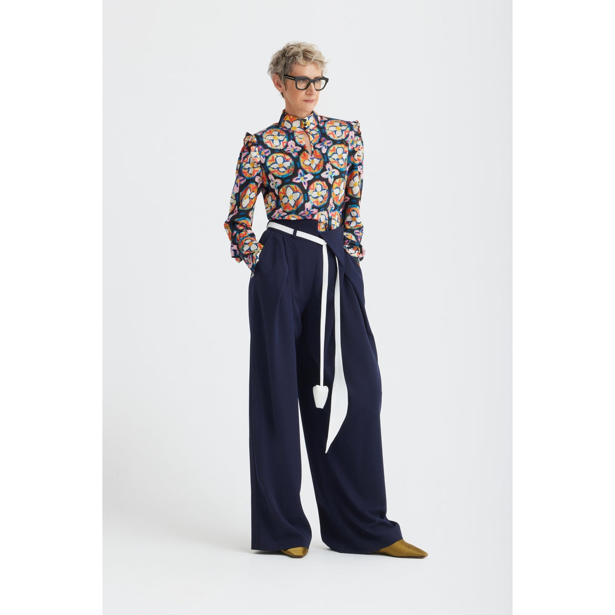 A person wears the JULIA ALLERT Fashion Forward Wide-Leg Pants &amp; Contrast Belt in navy, paired with a colorful blouse, mustard shoes, and black glasses, standing against a plain white background.