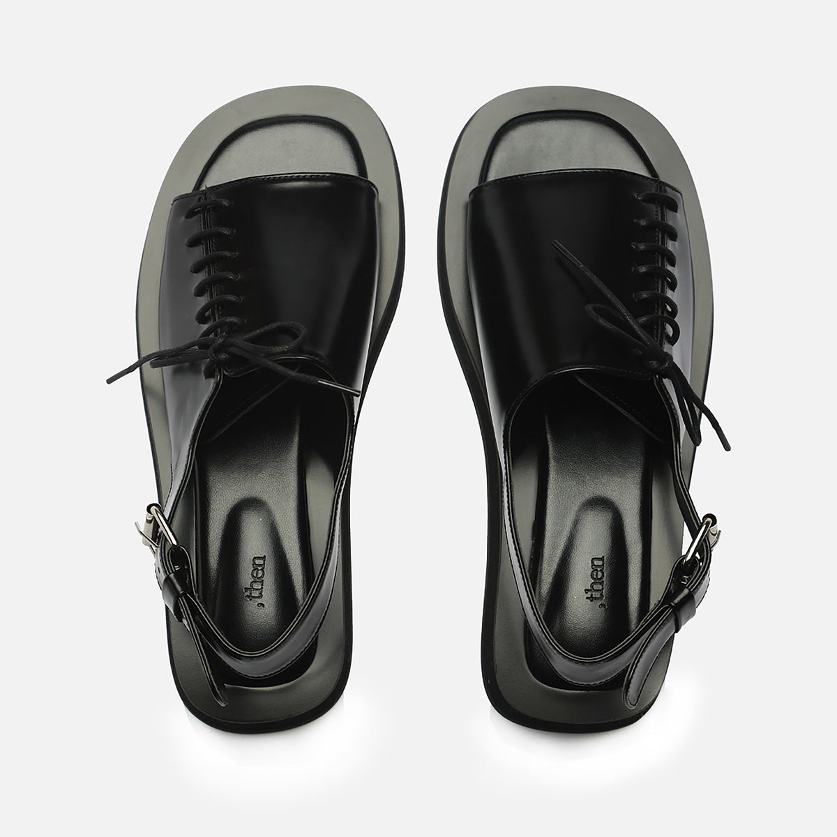 The THEN Black Leather Lace-Front Slingback Sandals feature square toes and a buckled heel strap, handcrafted in Korea, shown on a light gray background.