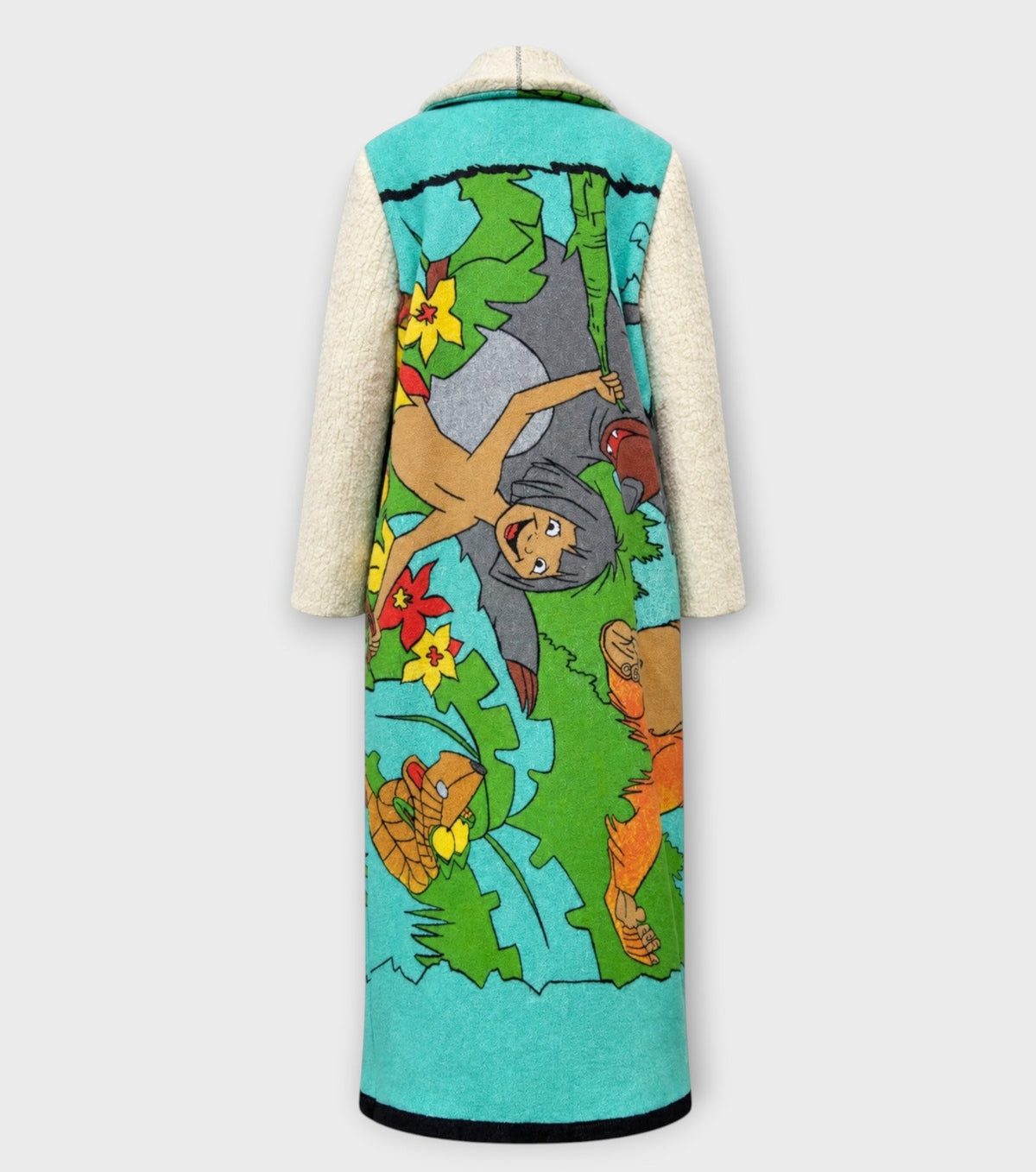 STUDIO WUNDERBAR Jungle Book Coat: turquoise graphic long coat with a Bagheera panther illustration from The Jungle Book and cream sleeves, upcycled one-of-a-kind coat, alternate angle, buy at DOORS NYC