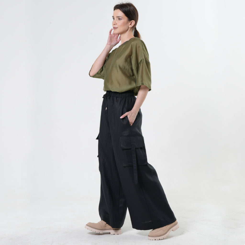 Wide-leg black linen cargo pants by METAMORPHOZA. Handmade with strap-detailed pockets and drawstring waist. Limited edition and summer-ready. Wide-leg black linen cargo pants by METAMORPHOZA. Handmade with strap-detailed pockets and drawstring waist. Limited edition and summer-ready.