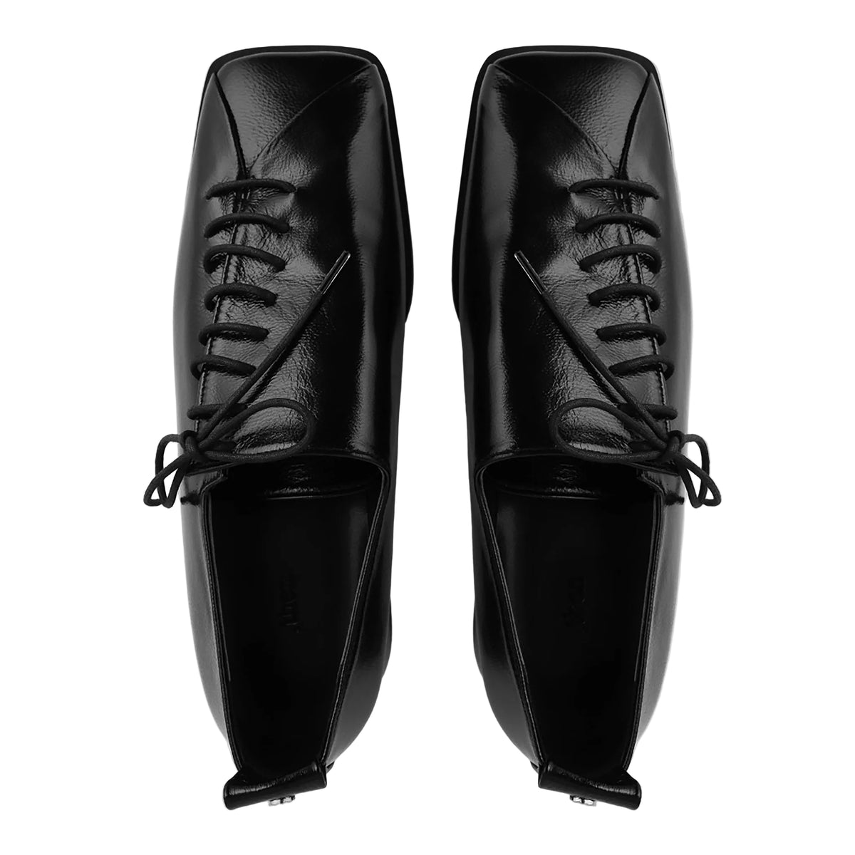 Pair of black leather shoes with square toes on a light gray background