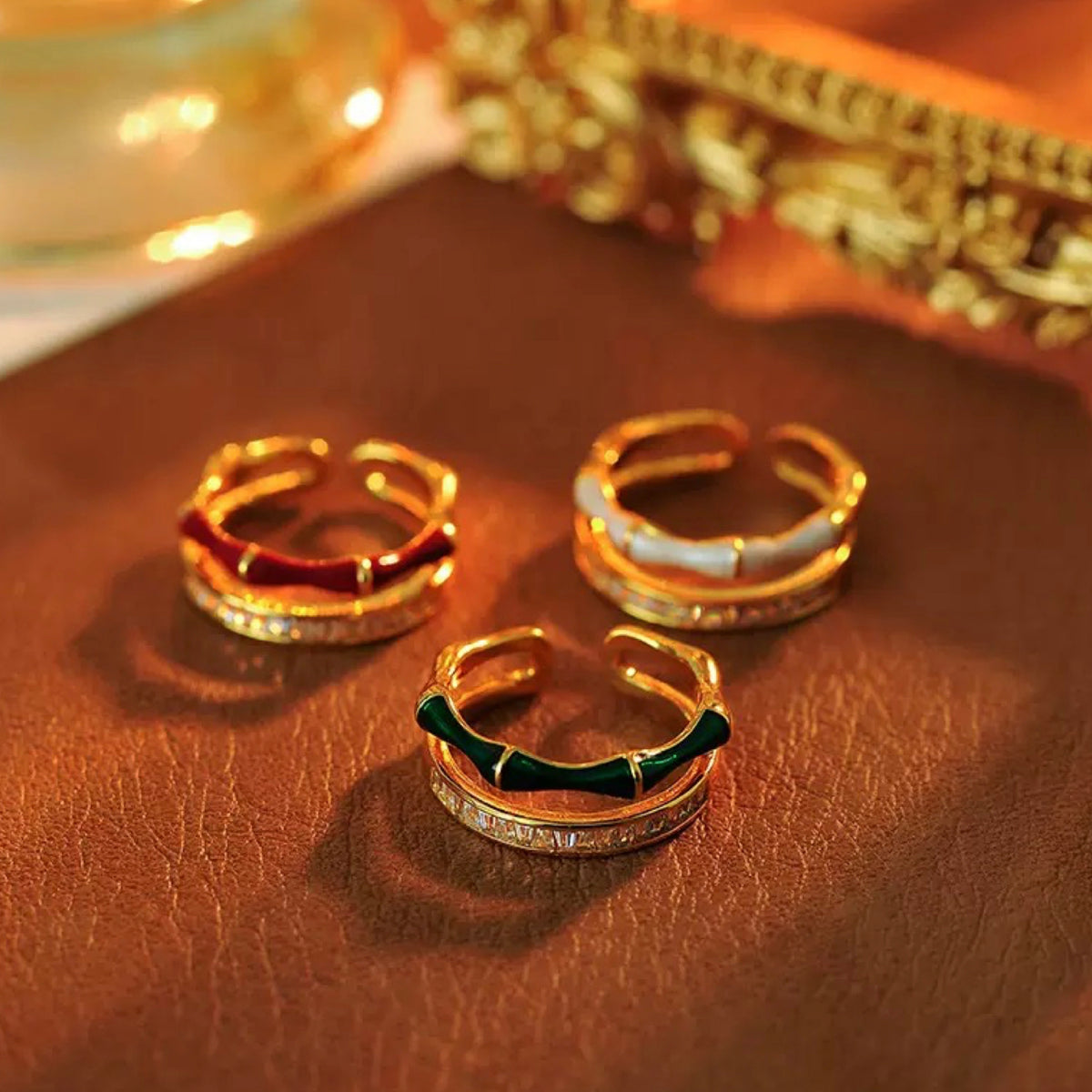 Three gold hoop earrings on a brown surface