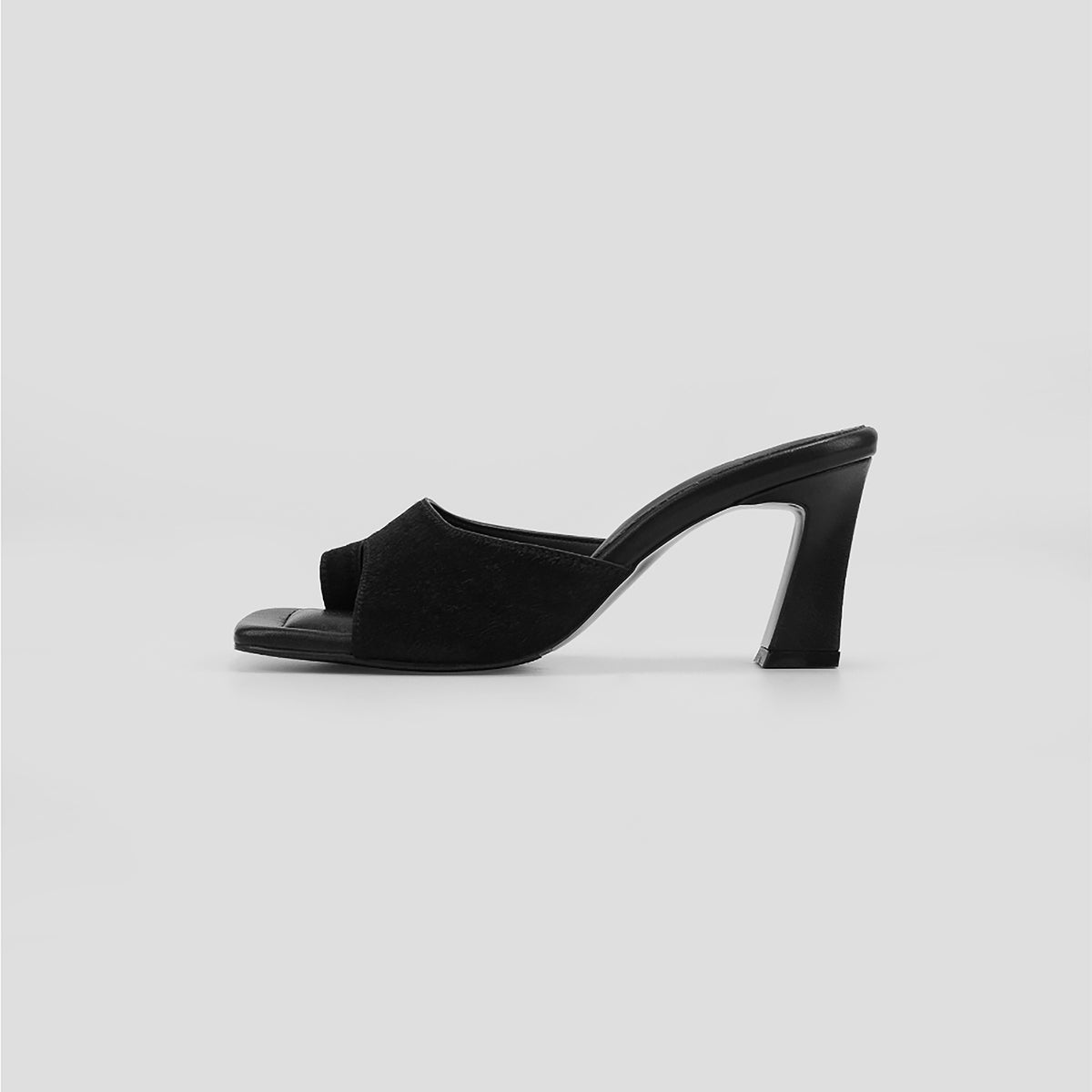 The THEN Black Suede Toe-Ring Heeled Mules feature a minimalist, open-toe design. Handcrafted in Korea, they're photographed from the side against a plain light gray background.