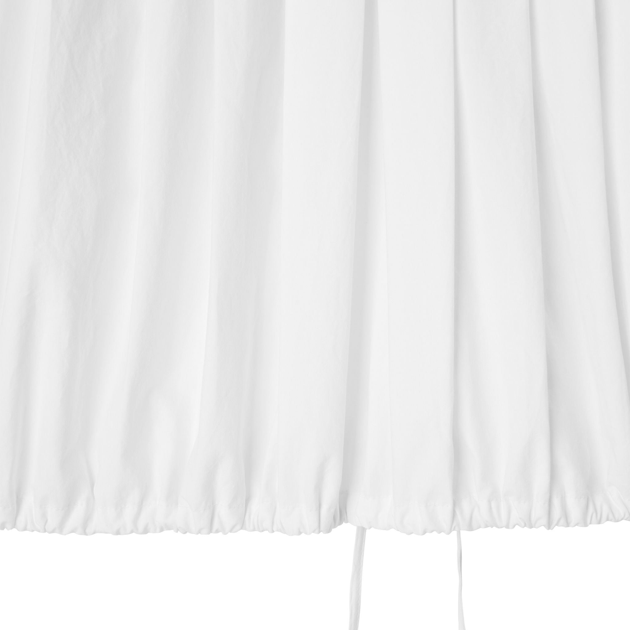 White curtain panel with a subtle pattern on a white background