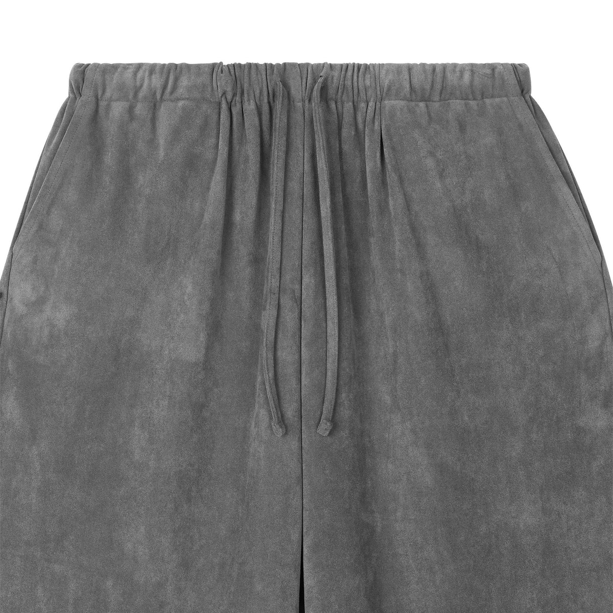 Close-up of ODDPRESENT Velour Suede Pants with an elastic waistband, adjustable drawstring, and discreet side pockets. These gray wide-leg pants combine comfort and style.