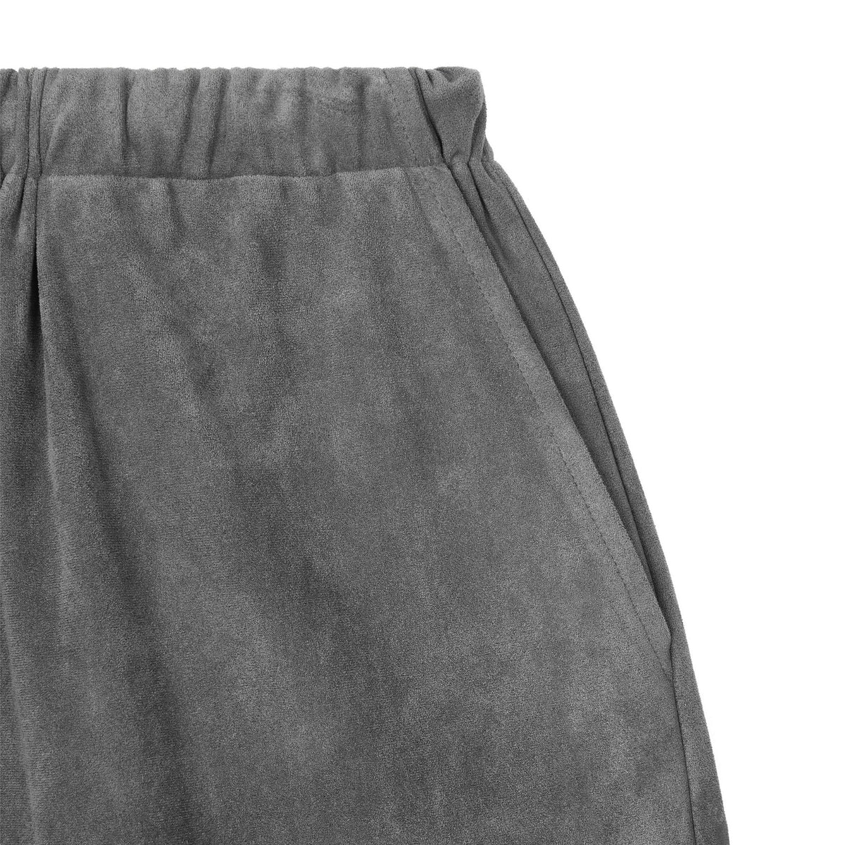 Close-up of ODDPRESENT Velour Suede Pants with an elastic waistband and slanted side pocket, displayed on a white background.