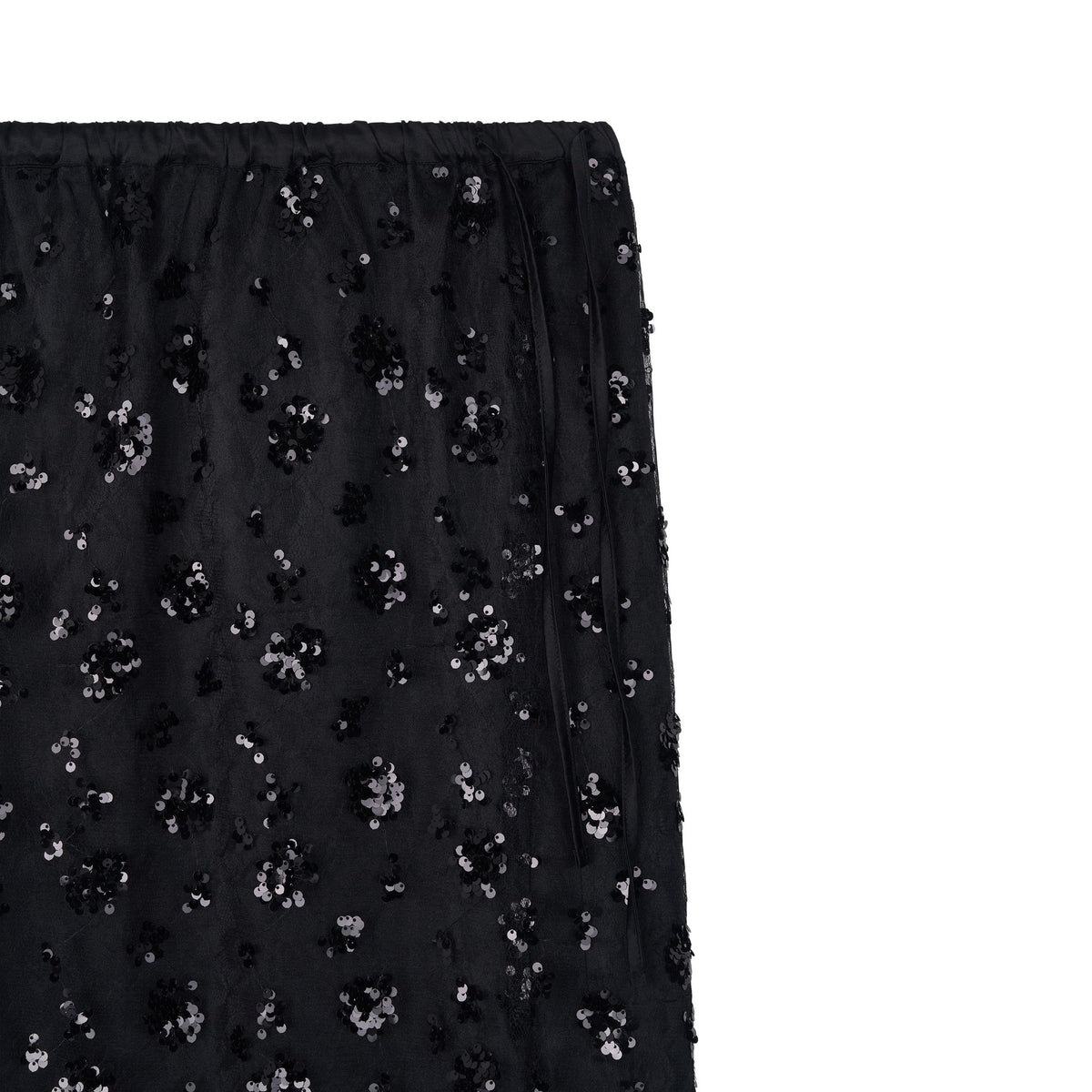 Close-up of the ODDPRESENT Sequin Beaded Skirt with Floral Detailing, showcasing shiny black sequins in a floral pattern on sheer fabric and an elastic waistband—ideal for evening events.