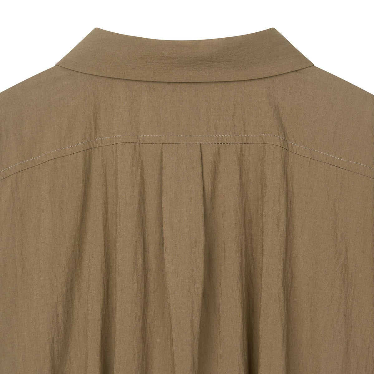 Close-up of a brown shirt collar on a white background