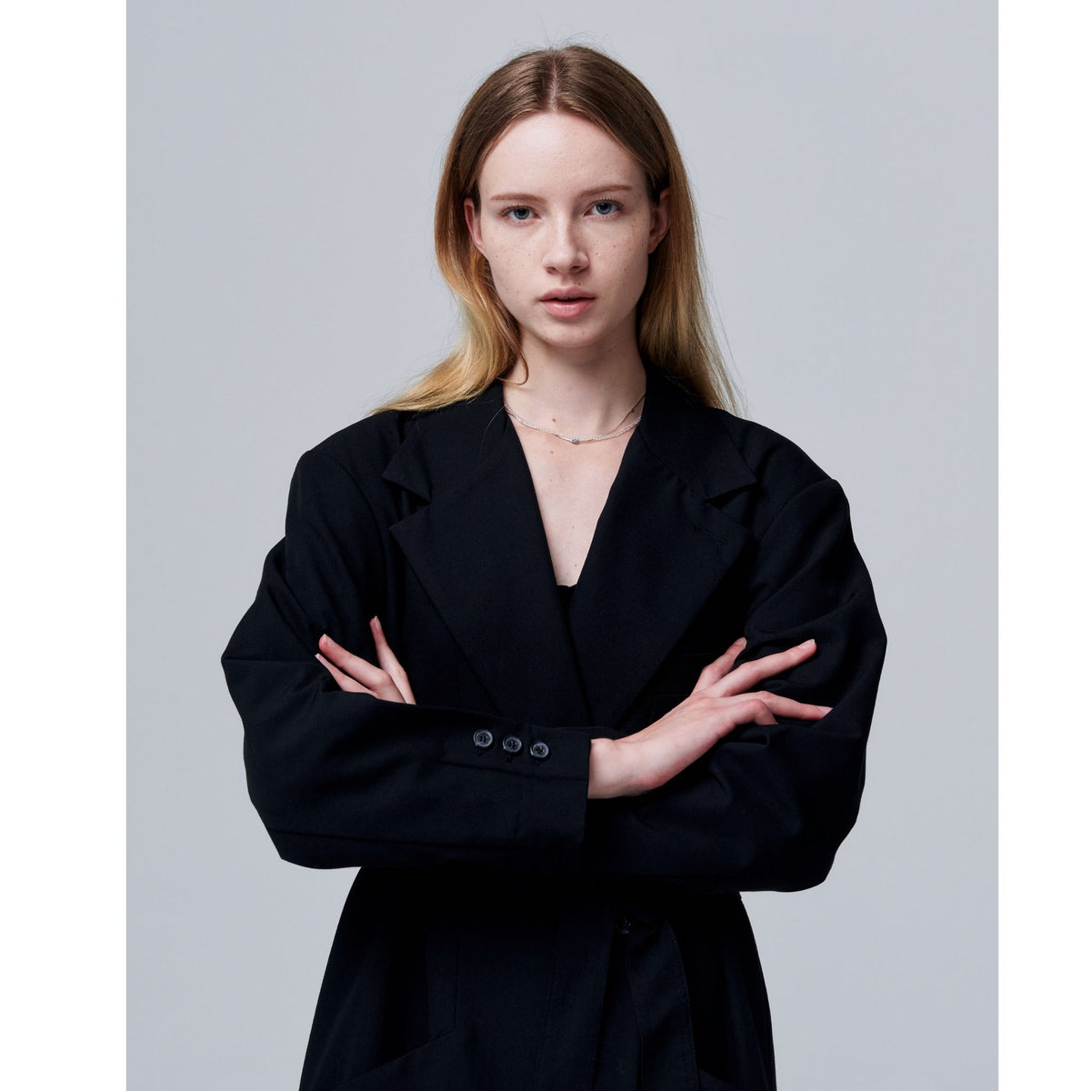 Woman wearing a black outfit with a plain background