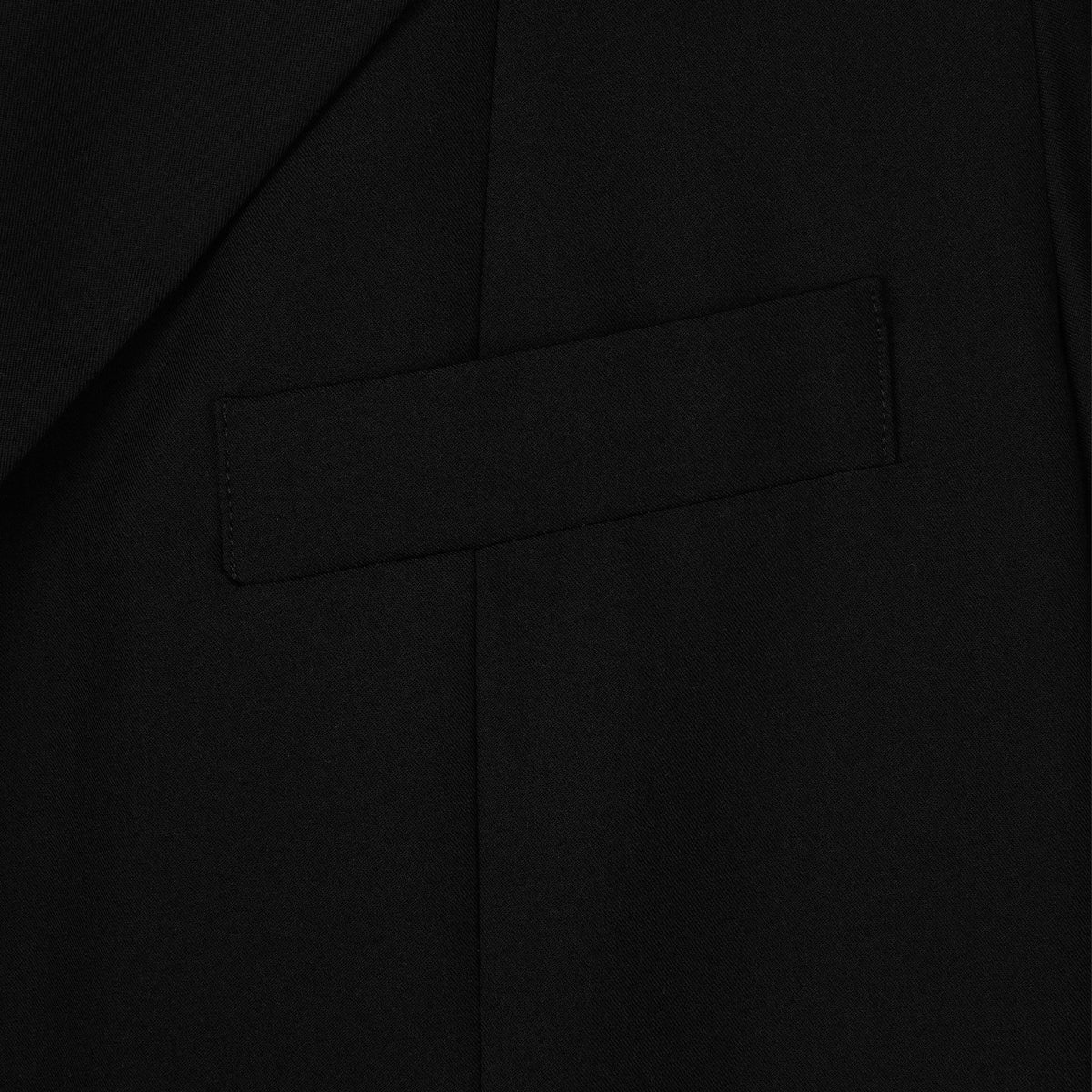 Close-up of a black suit jacket with a pocket detail