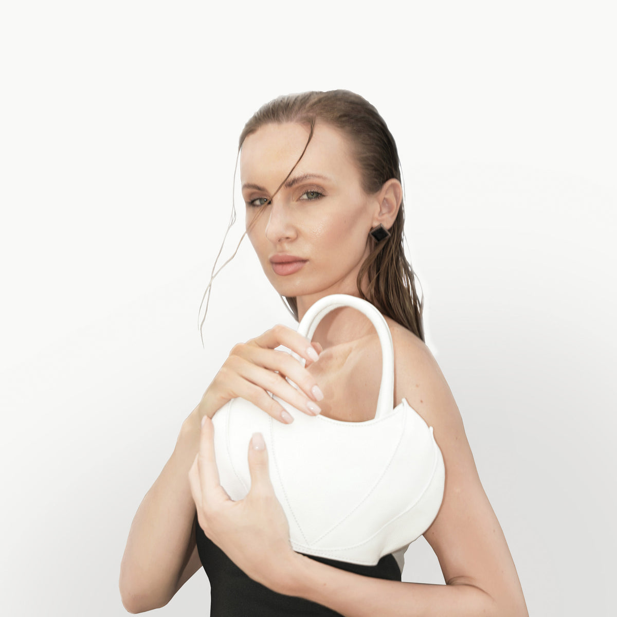 Model wearing black t-shirt with the Etherea Mini White