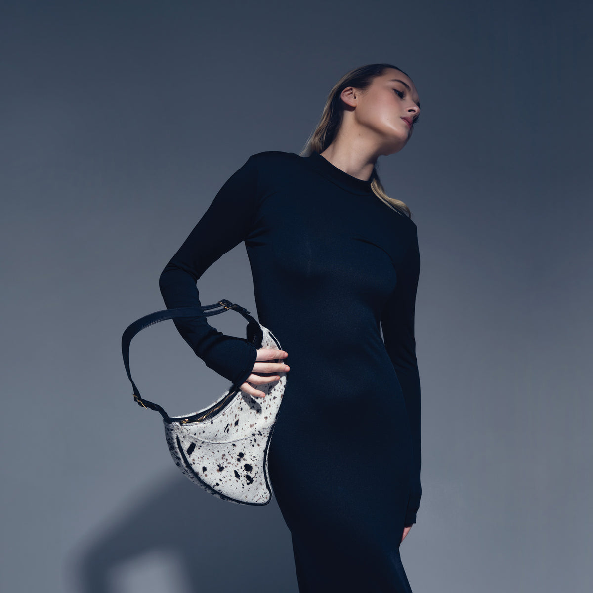 Model wearing black dress with the Arcana Dotted Calf Hair