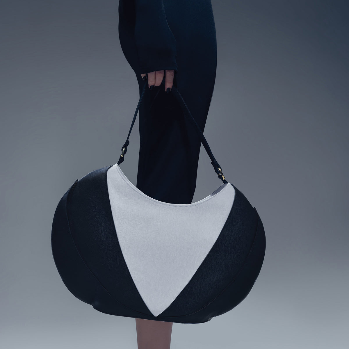 Model wearing black dress with the Etherea Hobo Black and White