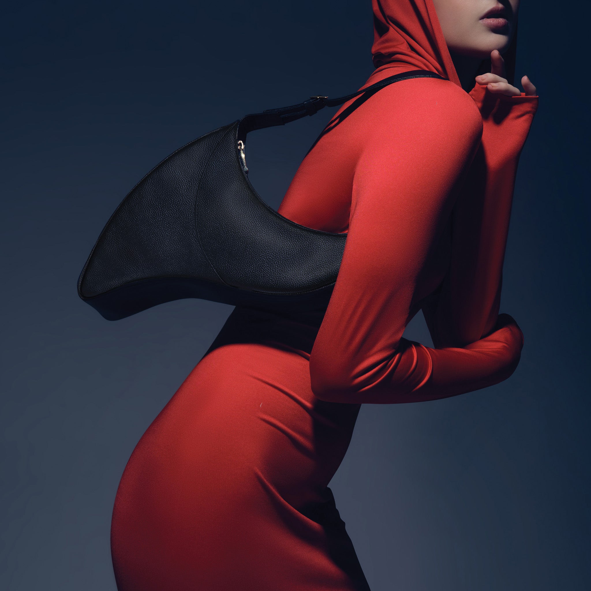 Model wearing red dress with the Arcana black