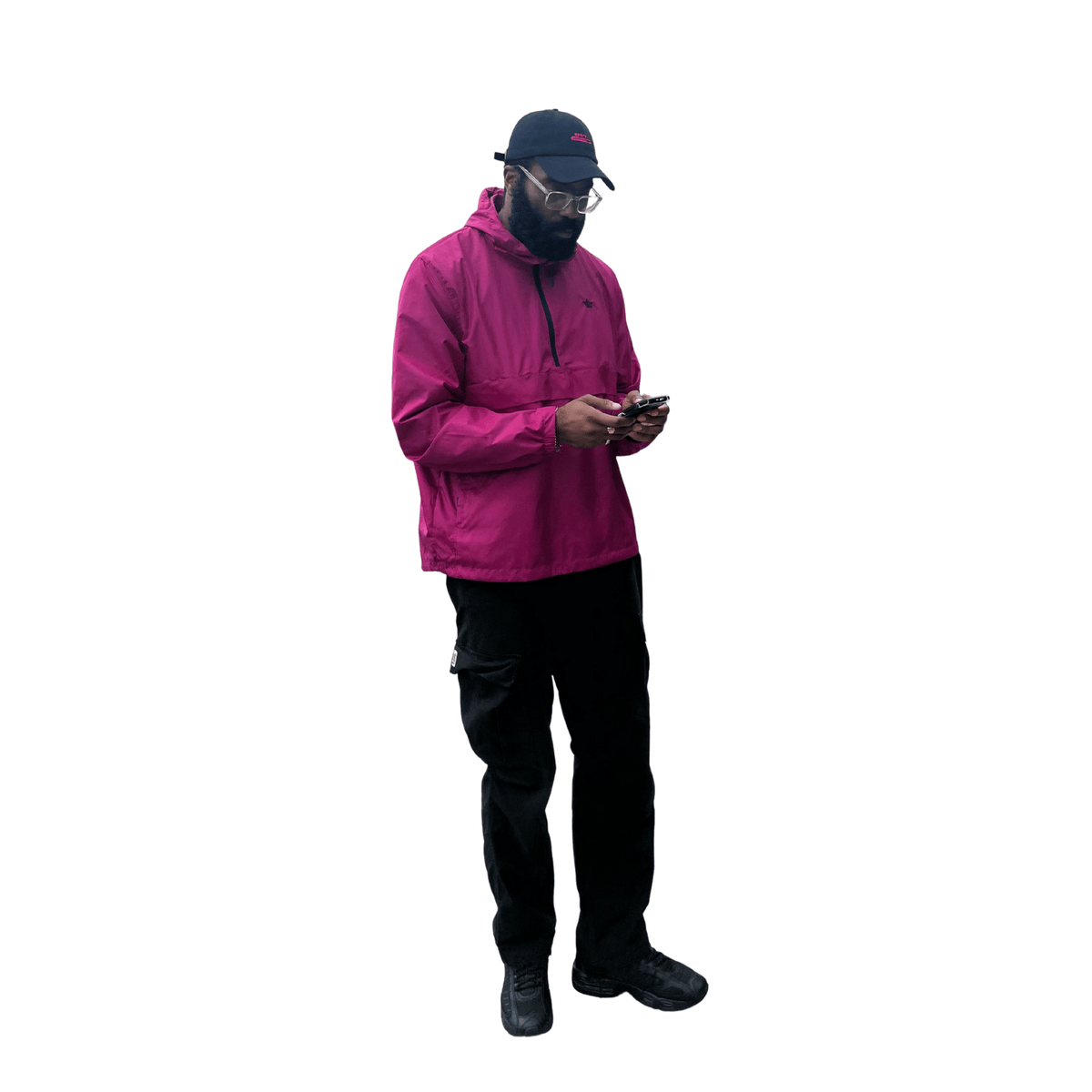 Person wearing a pink raincoat and black pants on a white background