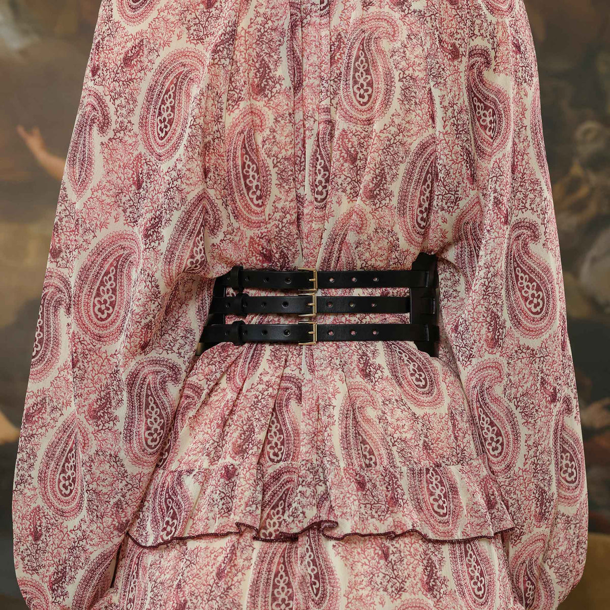 Patterned dress with a belt against a blurred natural background