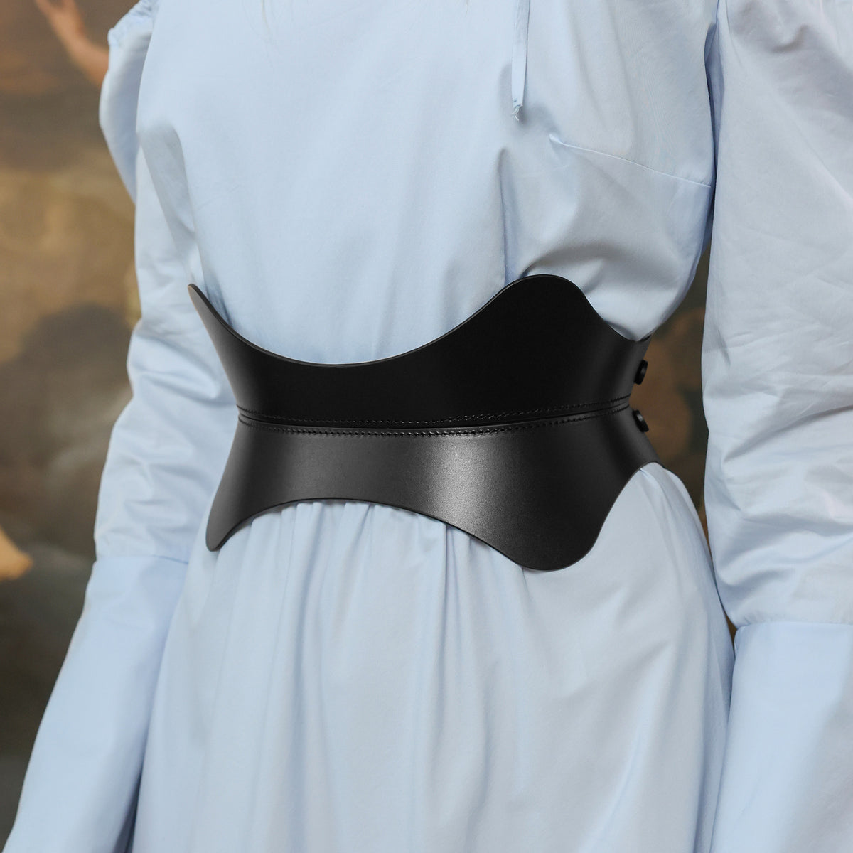 Person wearing a black belt with a blurred background
