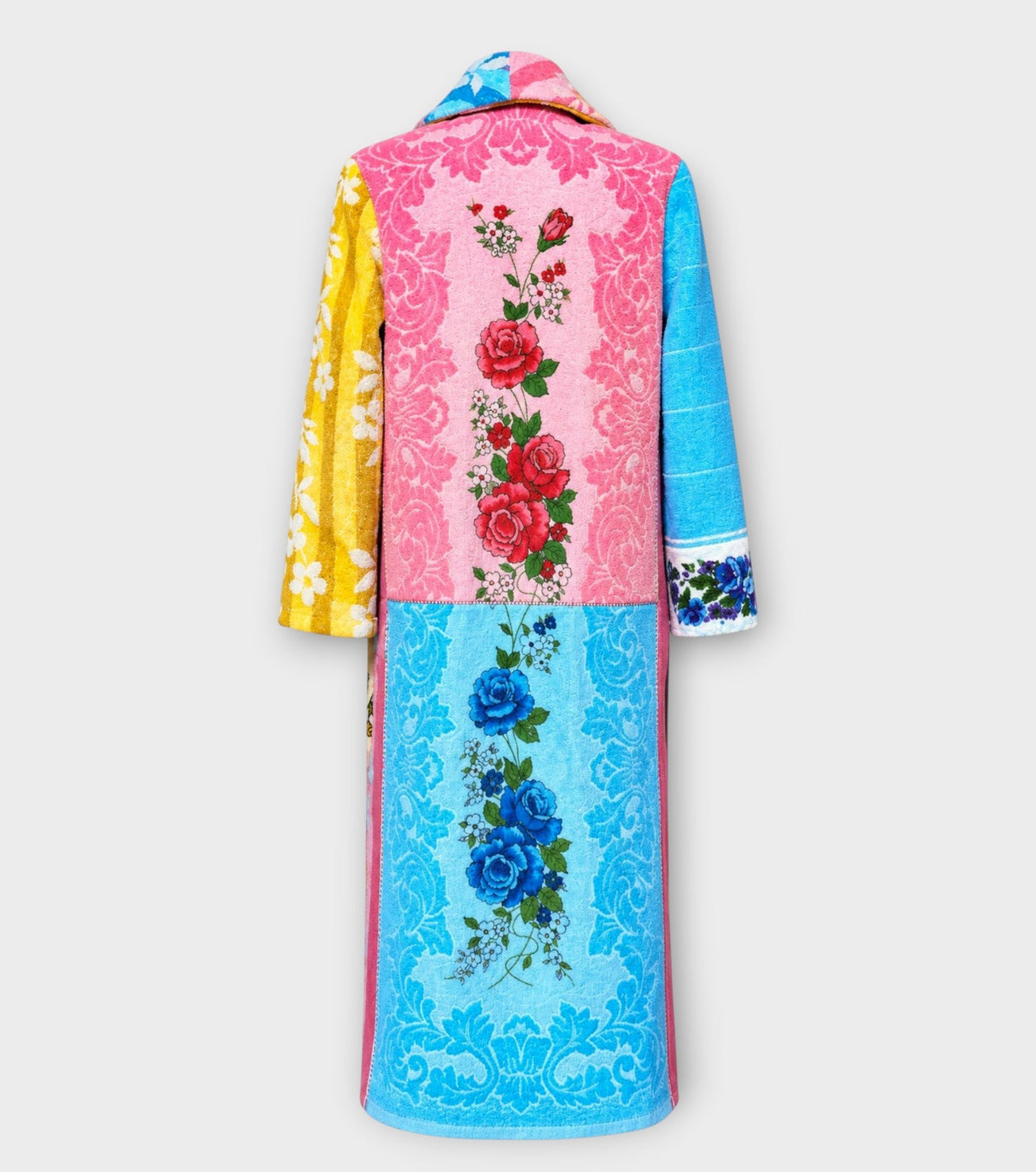 STUDIO WUNDERBAR Long Lunes Martes Coat: multicolor floral patchwork long coat with sunshine yellow florals, electric blue accents, pink and blue rose panels and vintage children illustrations, upcycled one-of-a-kind coat, alternate angle, buy at DOORS NYC