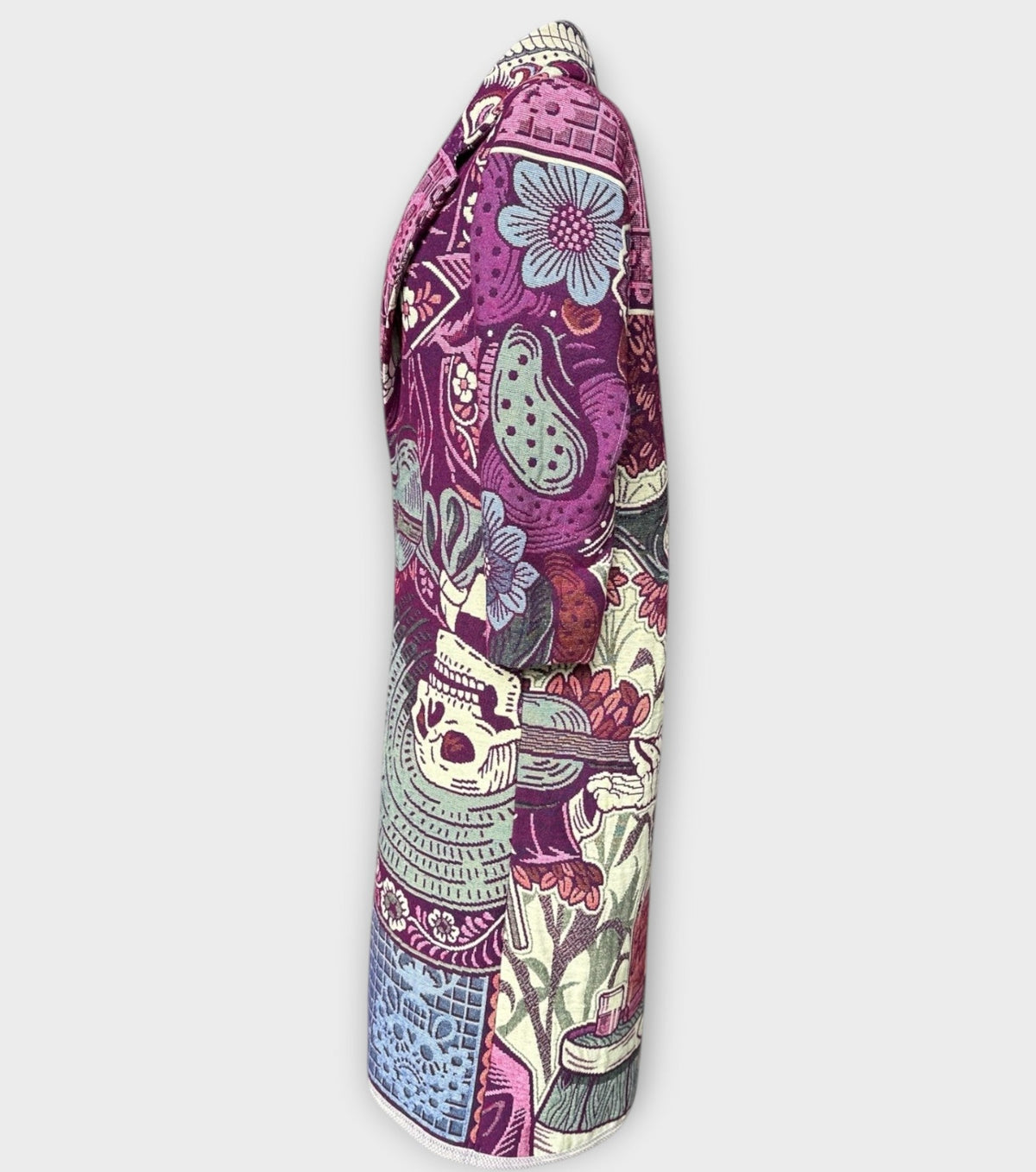 STUDIO WUNDERBAR Dia Del Muerto Coat: purple floral patchwork long coat with a magenta panel, botanical and geometric prints and skull tapestry details, upcycled one-of-a-kind coat, alternate angle, buy at DOORS NYC