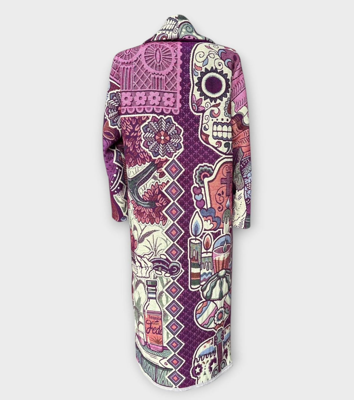 STUDIO WUNDERBAR Dia Del Muerto Coat: purple floral patchwork long coat with a magenta panel, botanical and geometric prints and skull tapestry details, upcycled one-of-a-kind coat, alternate angle, buy at DOORS NYC