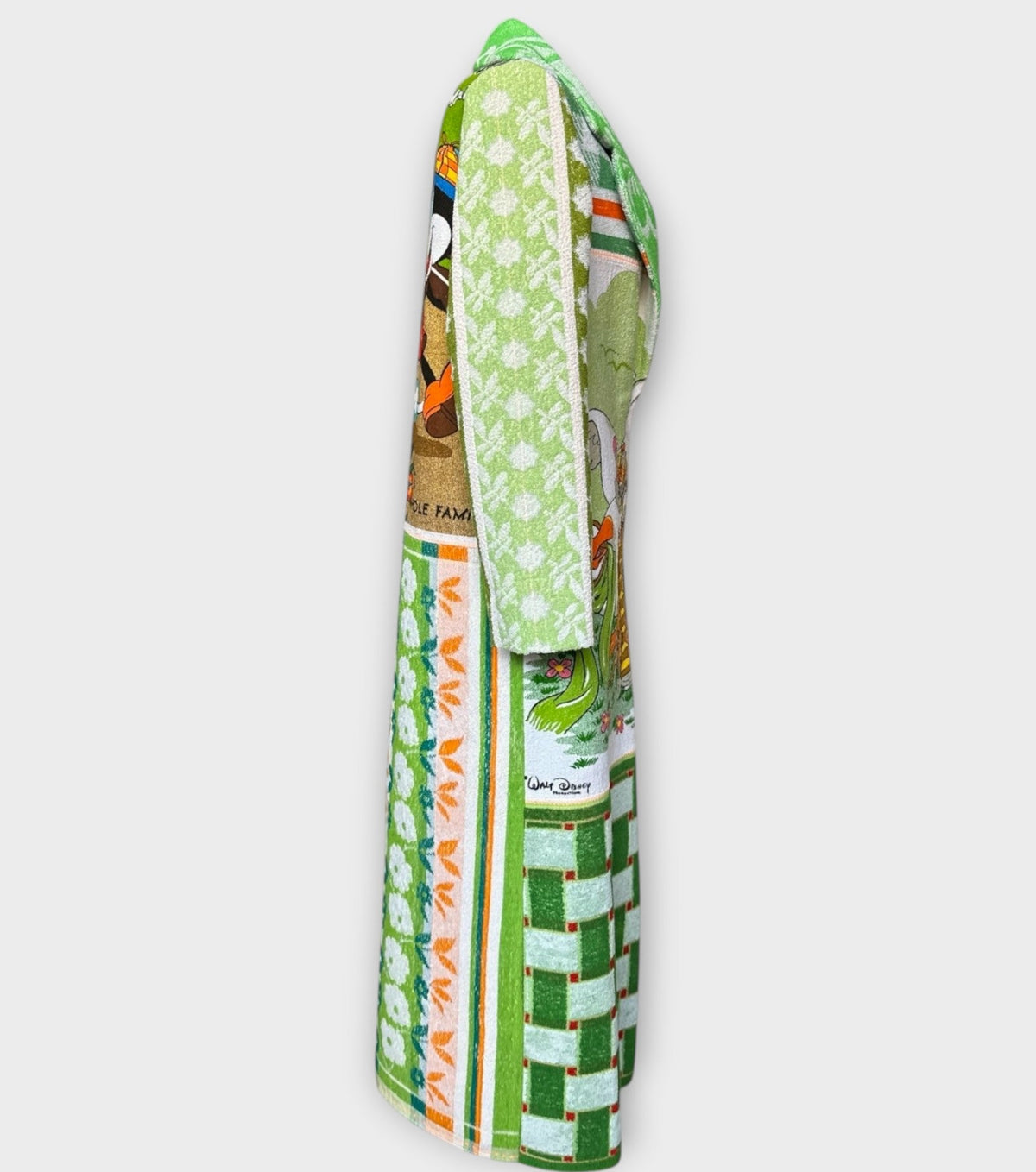 STUDIO WUNDERBAR Mouse With Big Ears Coat: green and orange patchwork long coat with gingham checks, floral motifs and a Mickey Mouse storybook panel, upcycled one-of-a-kind coat, alternate angle, buy at DOORS NYC