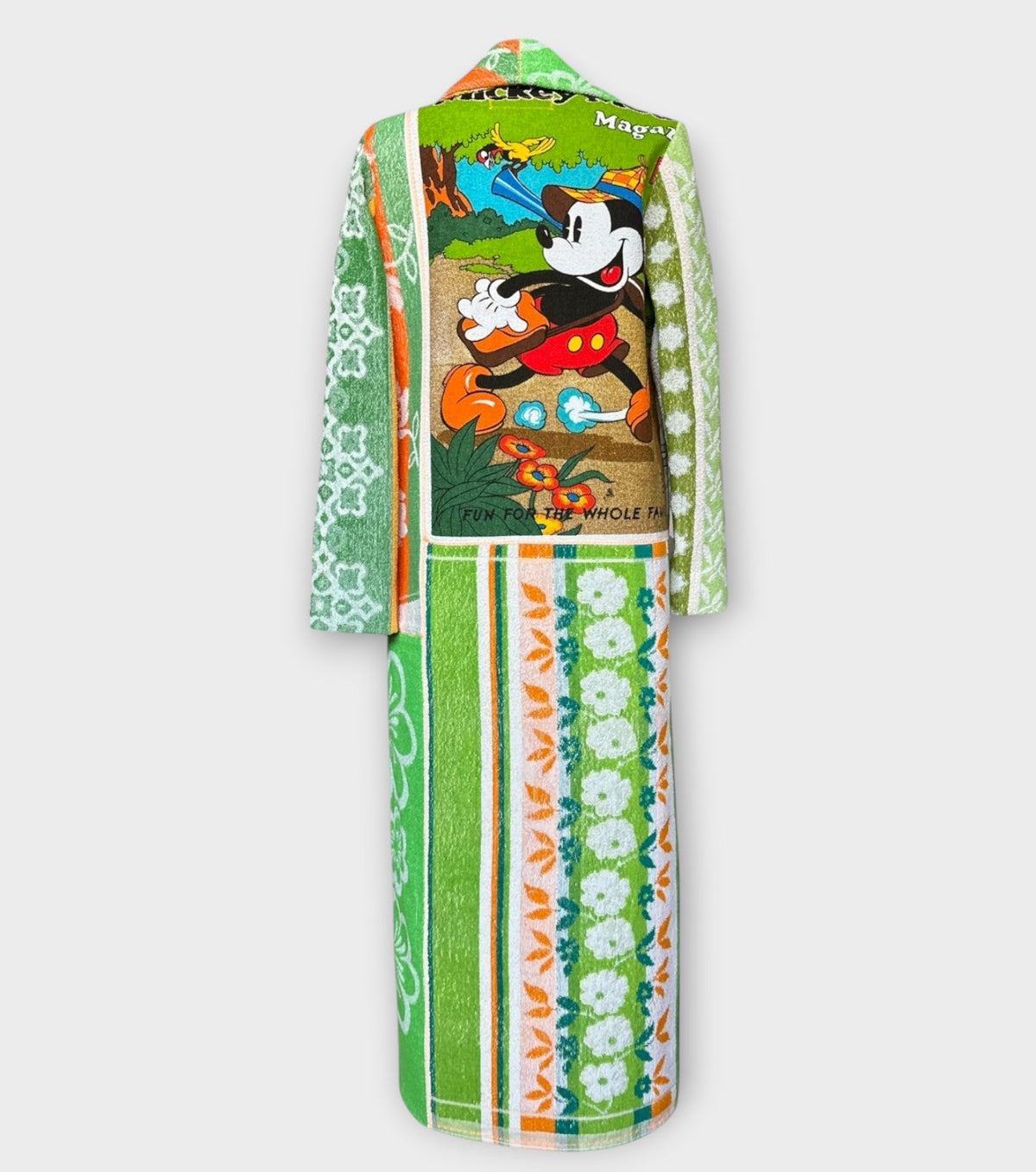 STUDIO WUNDERBAR Mouse With Big Ears Coat: green and orange patchwork long coat with gingham checks, floral motifs and a Mickey Mouse storybook panel, upcycled one-of-a-kind coat, alternate angle, buy at DOORS NYC