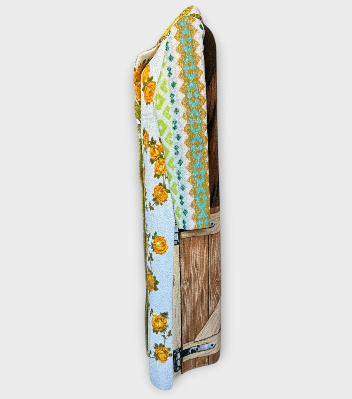 STUDIO WUNDERBAR Hella Horse Coat: blue floral patchwork long coat with yellow roses, striped panels, fringe hem and a horse panel on the back, upcycled one-of-a-kind coat, alternate angle, buy at DOORS NYC