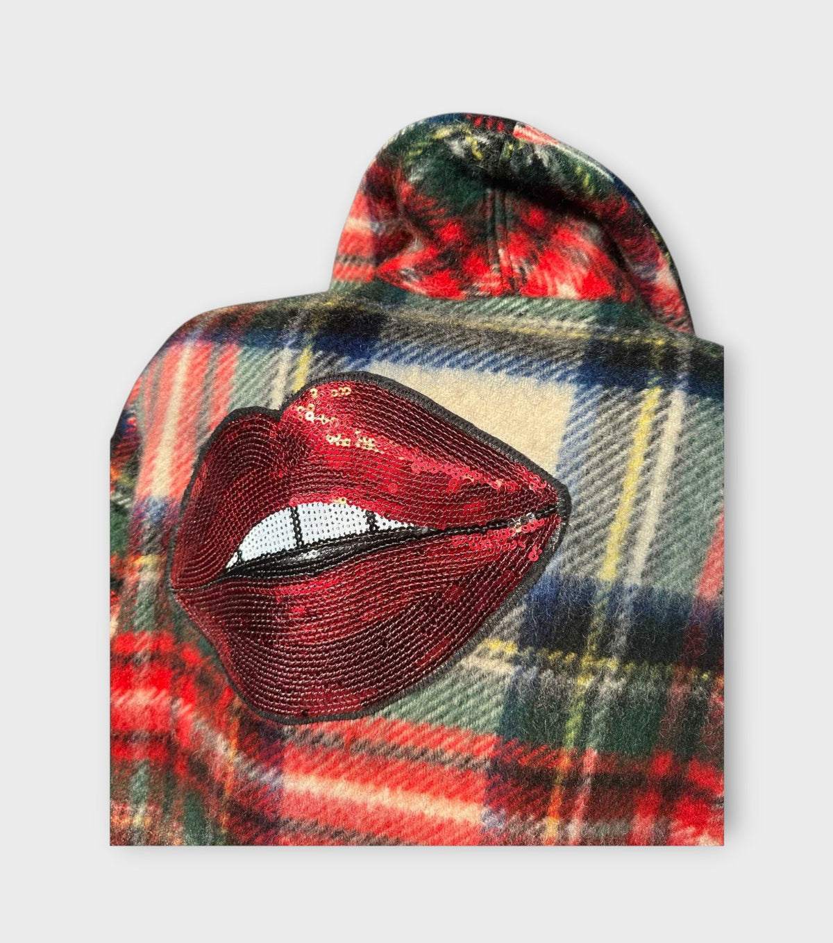 STUDIO WUNDERBAR Tartan Kiss Coat: multicolor red, green, navy and cream tartan long coat with red lip appliqués and oversized notched lapels, upcycled one-of-a-kind coat, alternate angle, buy at DOORS NYC