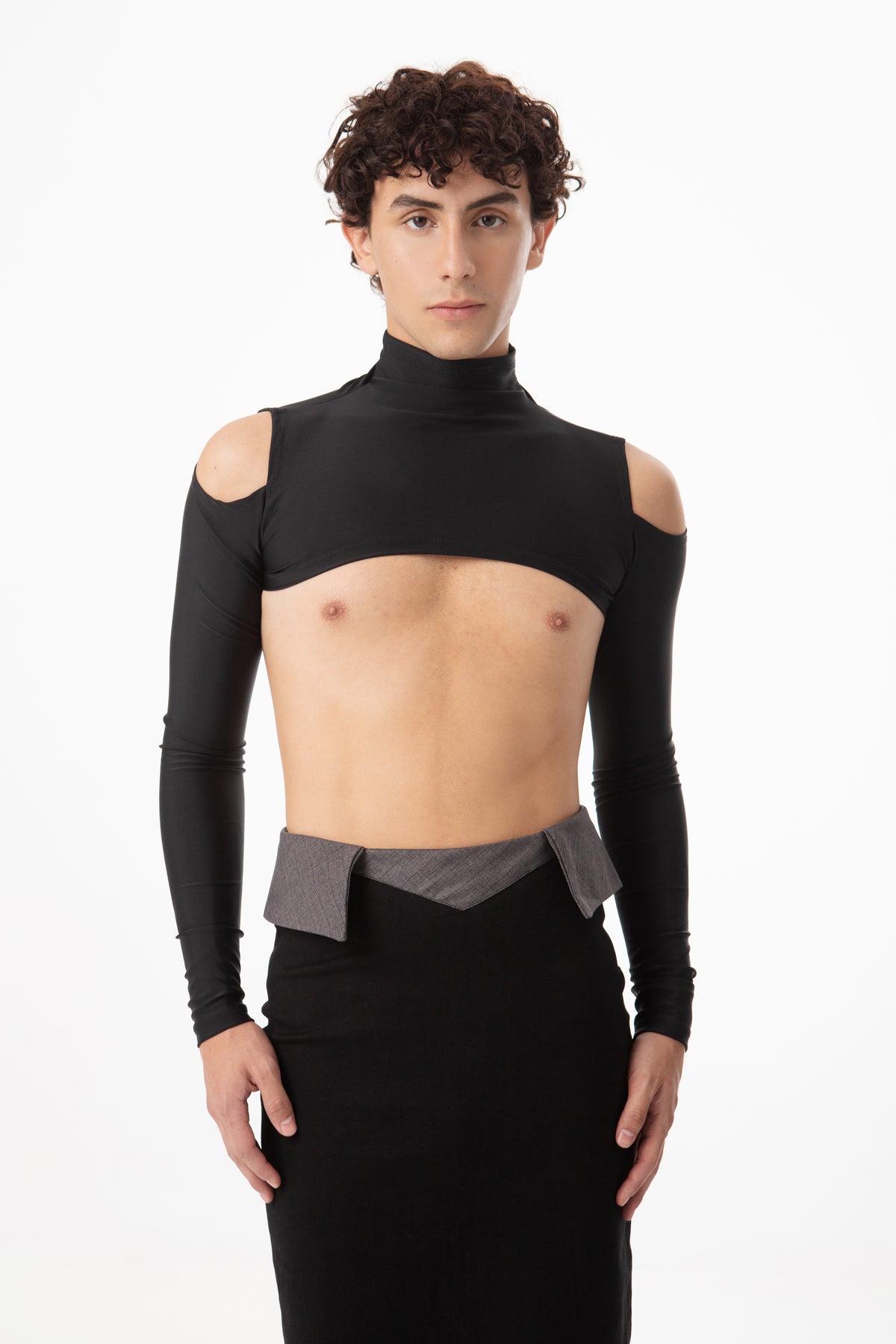 Man wearing a black turtleneck top with cut-out shoulders on a white background