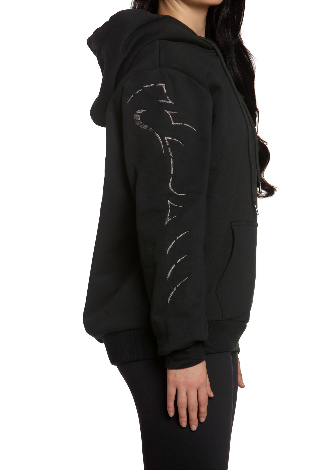 Black hoodie with a design on the back worn by a person on a white background