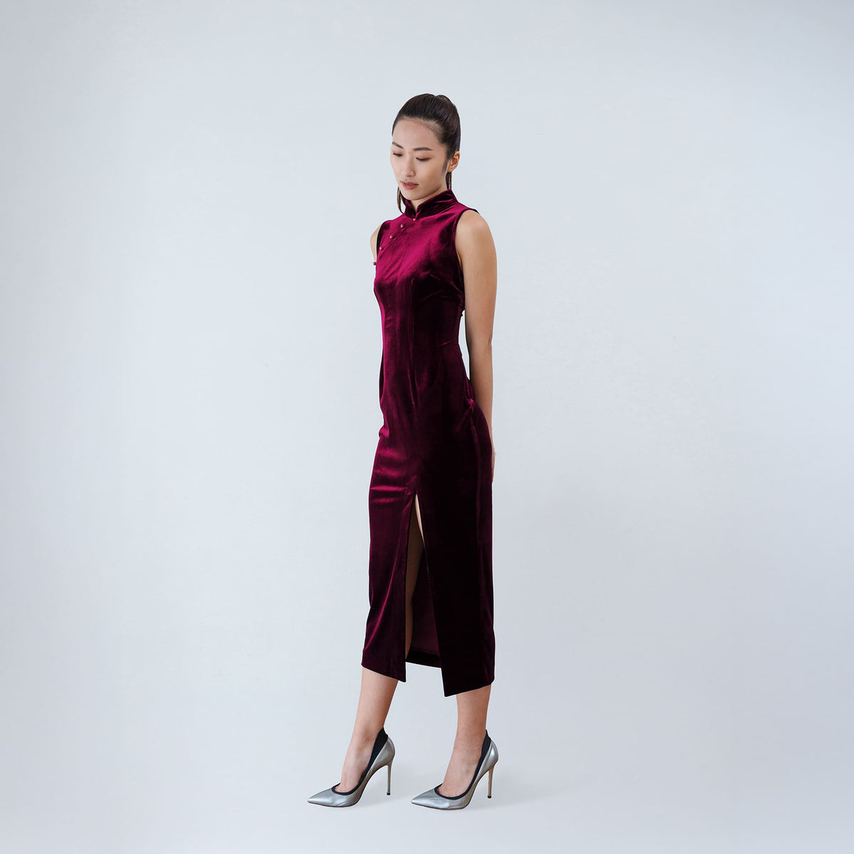 Qipology crimson red velvet sleeveless qipao dress with Mandarin collar, beaded detail and front slit, worn by model, look 4, buy at DOORS NYC