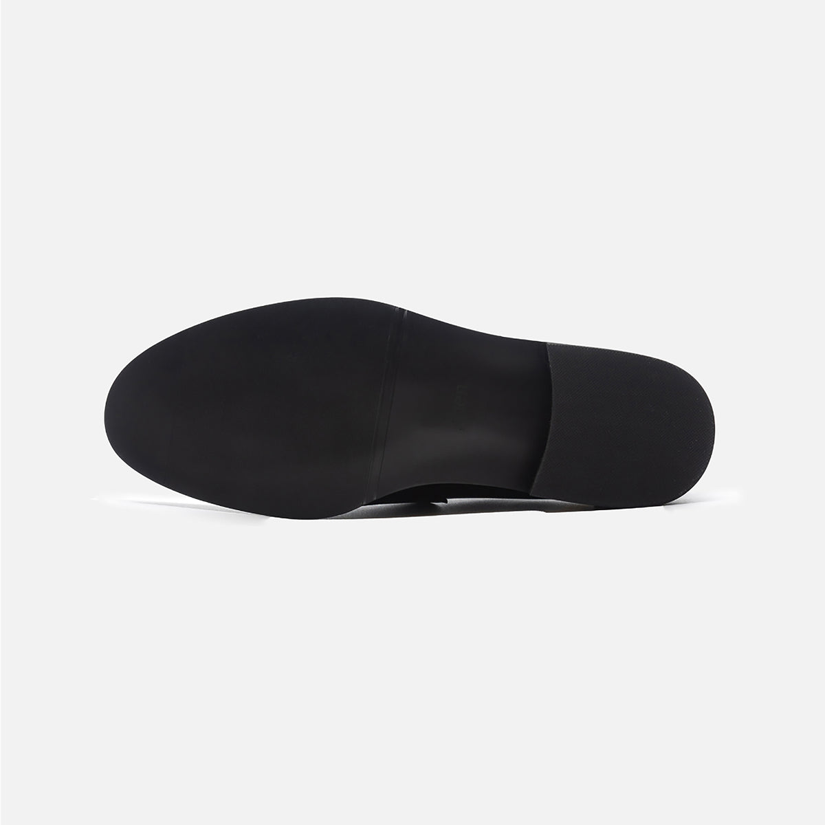 The THEN Black Leather Loafers with Cowhide Print Vamp are handmade in Korea and displayed from the bottom, showcasing their smooth, flat sole against a plain white background.