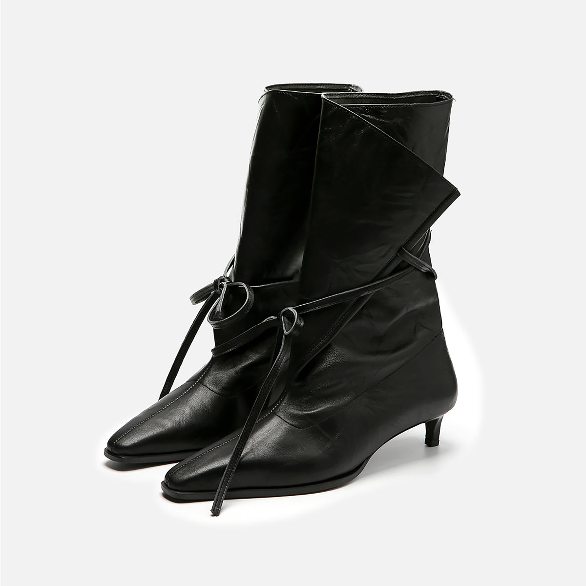The Black Folded-Top Leather Ankle Boots with Wraparound Tie by THEN are handcrafted in Korea, featuring pointed toes, low heels, a stylish folded top, and front wraparound laces tied in a knot.