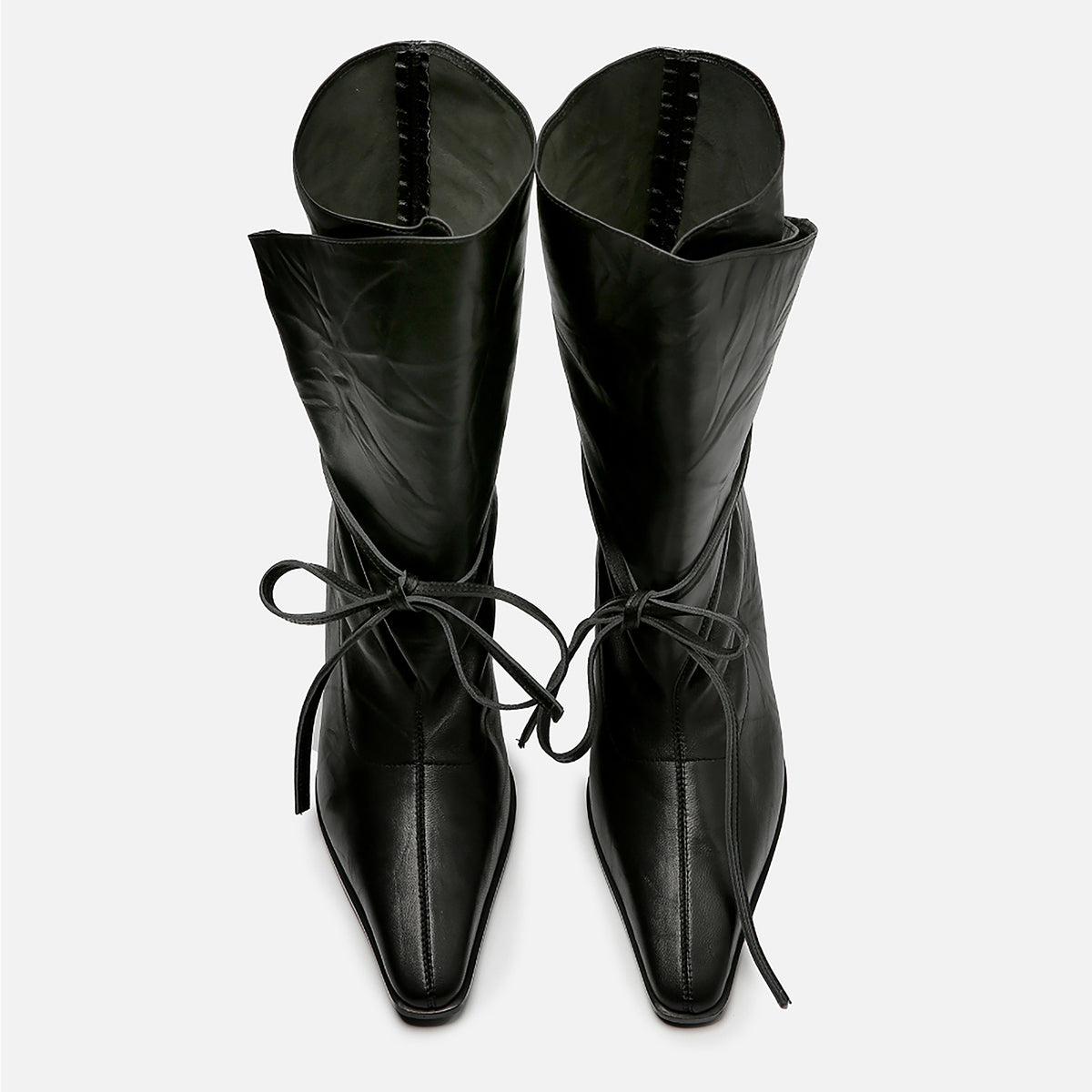 Top view of THEN Black Folded-Top Leather Ankle Boots with Wraparound Tie. Features high heels, pointed square toes, wide folded-over shafts, and long lace bows. Handcrafted in Korea; displayed side by side on a white background.