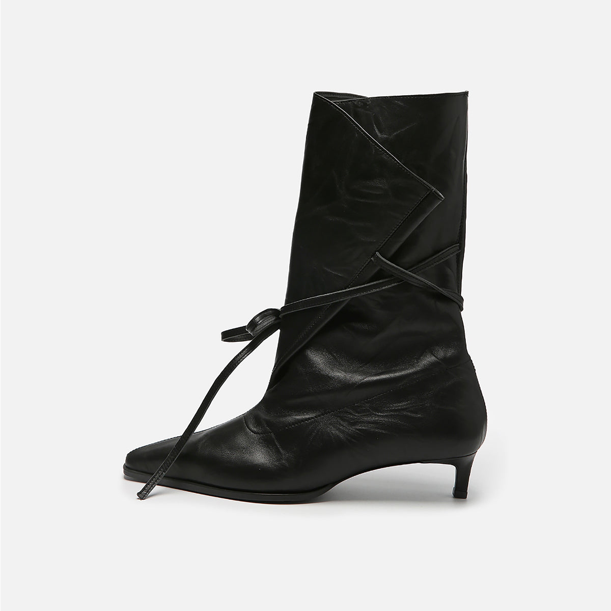 The THEN Black Folded-Top Leather Ankle Boots with Wraparound Tie are handcrafted in Korea, featuring a pointed toe, low kitten heel, and an asymmetrical flap—ideal minimalist boots with standout style.