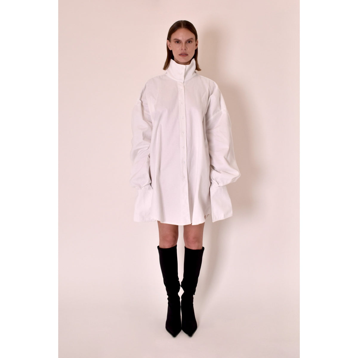 White shirt dress worn by a model on a plain background