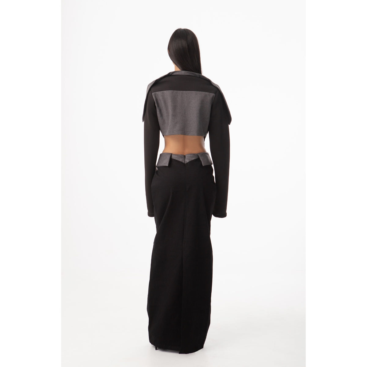 Person wearing a black and gray outfit on a white background