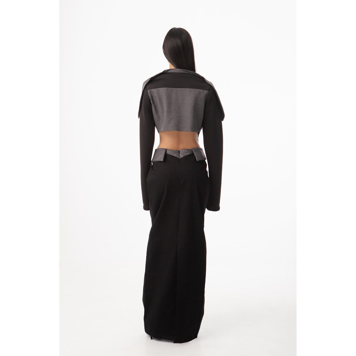 Person wearing a black and gray outfit on a white background