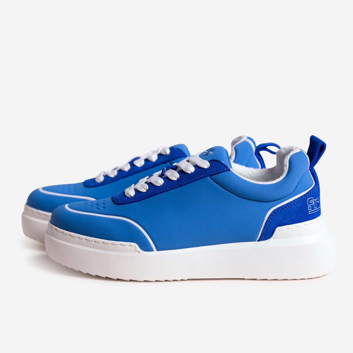 Blue sneakers with white soles on a white background
