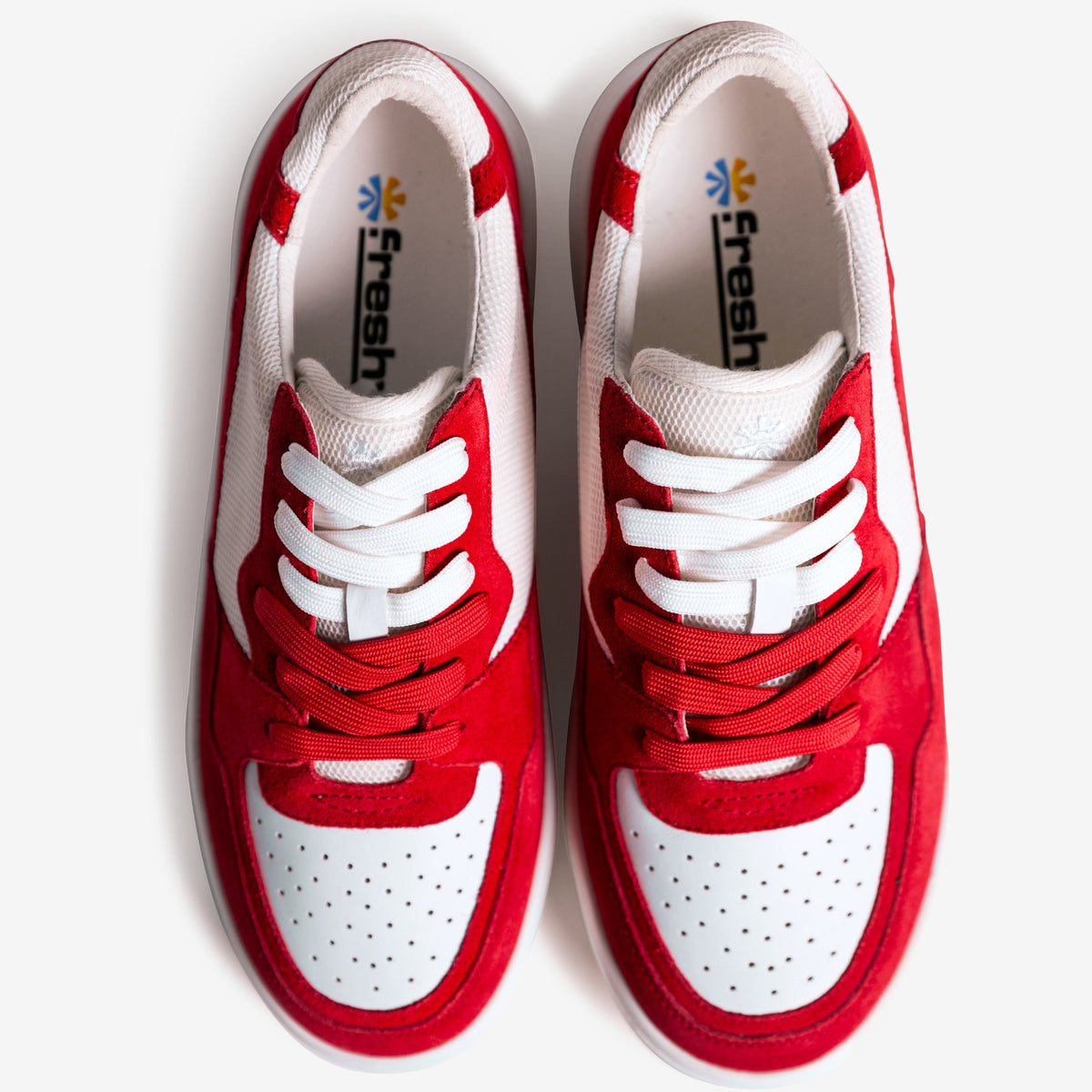 Red and white sneakers with 'fresh' branding on a white background