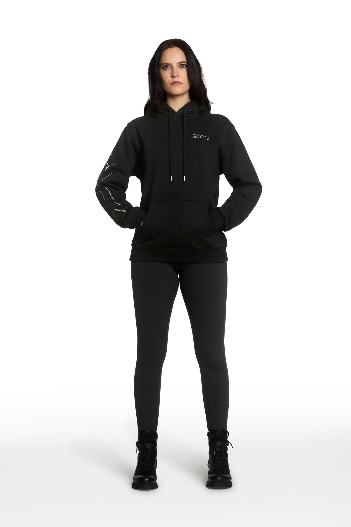 Person wearing a black hoodie and leggings with a brand logo on a white background